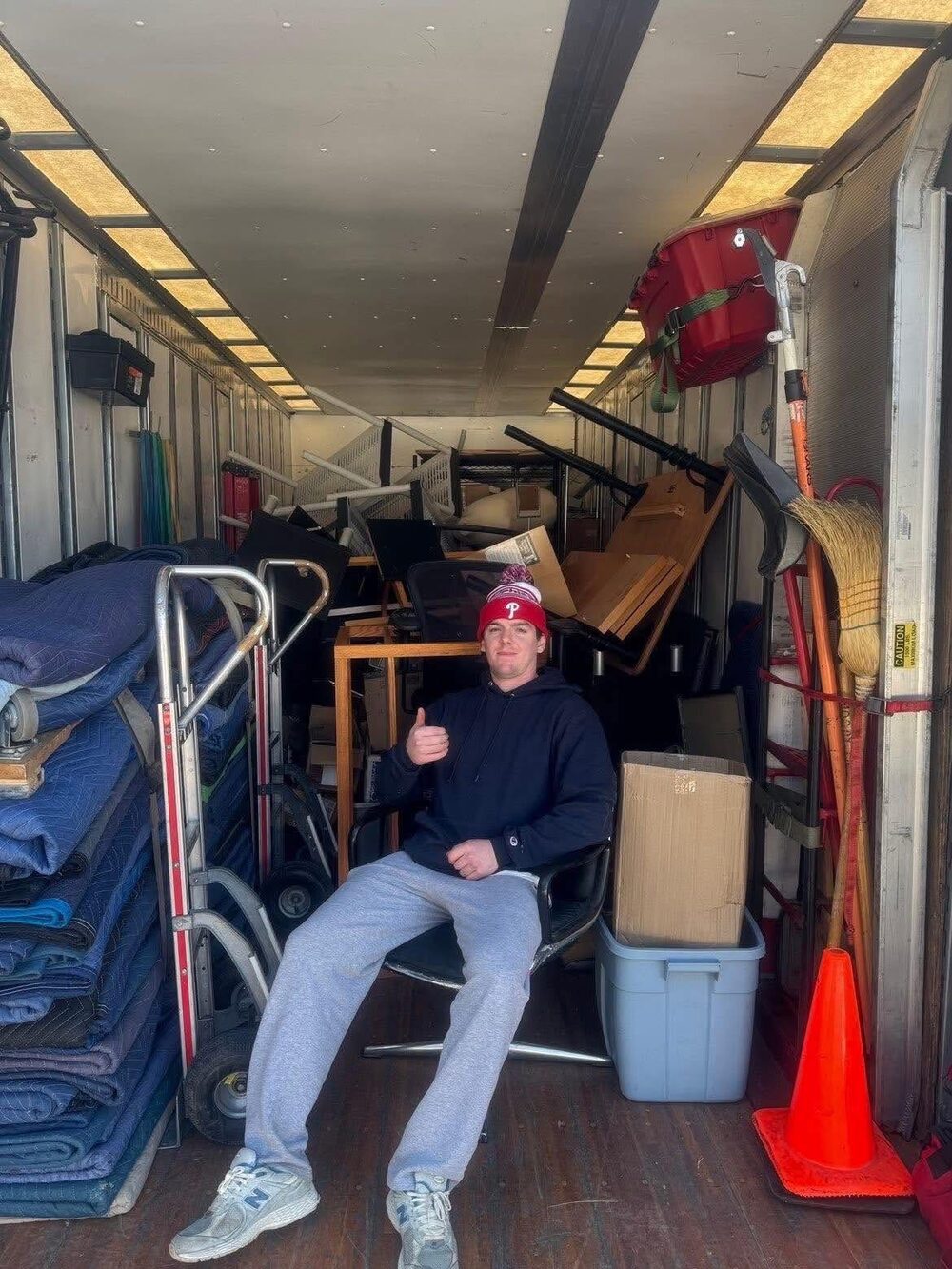 Moodys crew loading a hand truck inside a packed unit during a Bucks County cleanout