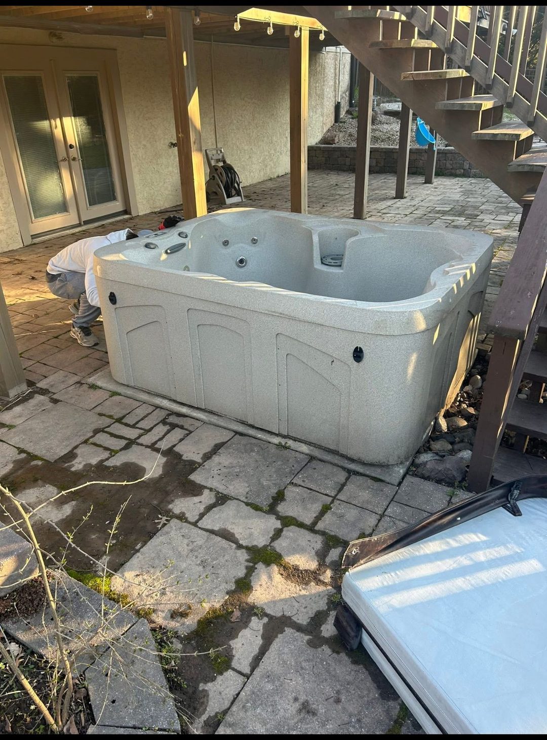 Old hot tub on a patio ready for removal